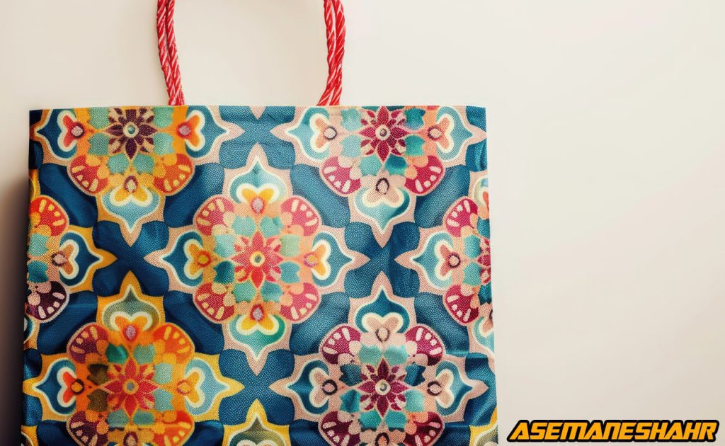 کیف دستی پارچه ای و کاغذی با طرح گلهای رنگارنگ روی زمینه آبی | مناسب خرید و هدیه دادن با دسته قرمز.