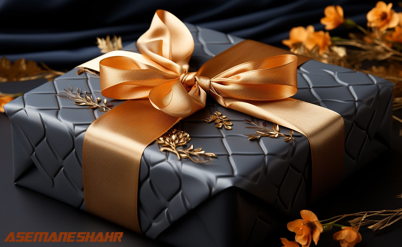 جعبه هدیه مشکی لوکس با روبان طلایی و تزیین گل.